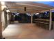 Spacious covered patio with ceiling fans, bar seating, and a serene backyard fountain for outdoor entertaining at 5854 Sheila Ave, Las Vegas, NV 89108