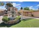 Beautifully landscaped backyard with a water fountain, covered patio, and ample space for outdoor activities at 5854 Sheila Ave, Las Vegas, NV 89108