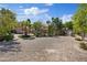 Spacious backyard with gravel, sparse landscaping, and a partial view of the outdoor kitchen at 5854 Sheila Ave, Las Vegas, NV 89108