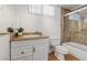 Functional bathroom features a shower over tub and vanity with built-in storage at 5854 Sheila Ave, Las Vegas, NV 89108