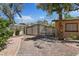 Beautiful brick paver driveway leading to a gate and well-maintained landscaping at 5854 Sheila Ave, Las Vegas, NV 89108
