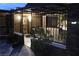 Night view of the property's landscaped entrance courtyard, accessed through a wrought iron security gate at 5854 Sheila Ave, Las Vegas, NV 89108