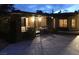 Night view of the property's landscaped entrance courtyard, accessed through a wrought iron security gate at 5854 Sheila Ave, Las Vegas, NV 89108