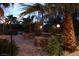 Backyard with stone pavers, an outdoor seating area, a fire pit and landscaping at 5854 Sheila Ave, Las Vegas, NV 89108