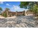 Circular driveway leading to a well-maintained home with a two-car garage and mature trees at 5854 Sheila Ave, Las Vegas, NV 89108