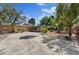 Spacious circular driveway with mature trees and landscaping leading up to the home at 5854 Sheila Ave, Las Vegas, NV 89108