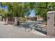 Inviting gated entrance with mature landscaping and a sprawling driveway at 5854 Sheila Ave, Las Vegas, NV 89108