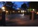 Night view of the property's circular driveway, with wrought iron security gate and lighting at 5854 Sheila Ave, Las Vegas, NV 89108