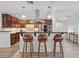 Stylish kitchen with dark wood cabinetry, pendant lighting, and seating at the breakfast bar at 5854 Sheila Ave, Las Vegas, NV 89108