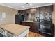 Efficient kitchen with dark cabinets, modern appliances, ample counter space, and an island for food prep at 5854 Sheila Ave, Las Vegas, NV 89108