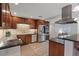Open kitchen featuring wood cabinets, stainless steel appliances, granite counters, and tile backsplash at 5854 Sheila Ave, Las Vegas, NV 89108