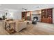 Open living area with a stone fireplace, built-in cabinets, and wood-look tile flooring at 5854 Sheila Ave, Las Vegas, NV 89108