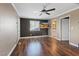 A room with hardwood floors that includes a television, door, and view into a bathroom at 5854 Sheila Ave, Las Vegas, NV 89108