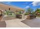 Backyard features an outdoor kitchen area with a bar and a grill under a large pergola with fan at 5854 Sheila Ave, Las Vegas, NV 89108