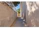 A narrow side yard with block walls and gravel at 5854 Sheila Ave, Las Vegas, NV 89108