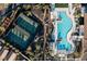 An aerial view showcases community amenities, including tennis courts and a resort-style swimming pool with ample seating at 6 Rock Mount Ct, Henderson, NV 89012