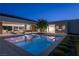 Stunning backyard featuring a modern pool, outdoor kitchen, and seamless indoor-outdoor living space for entertaining at 6 Rock Mount Ct, Henderson, NV 89012
