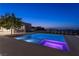 Luxury backyard with a modern pool, step-down spa, and outdoor kitchen with views of the city skyline at 6 Rock Mount Ct, Henderson, NV 89012