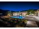 Inviting backyard with a modern pool, outdoor kitchen, and well-maintained landscaping perfect for evening relaxation at 6 Rock Mount Ct, Henderson, NV 89012