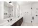 Modern bathroom featuring double sinks, sleek fixtures, marble countertops, and a glass-enclosed shower at 6 Rock Mount Ct, Henderson, NV 89012