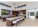 Gourmet kitchen featuring large island with seating and modern lighting fixtures at 6 Rock Mount Ct, Henderson, NV 89012