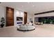 Open-concept living room with modern decor, a fireplace and disappearing glass wall leading to the patio at 6 Rock Mount Ct, Henderson, NV 89012
