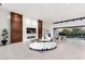 Open living space features a custom wood feature wall, fireplace, modern furniture, and seamless indoor/outdoor flow at 6 Rock Mount Ct, Henderson, NV 89012