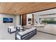 Modern living room with wood ceiling, fireplace, and large sliding glass doors at 6 Rock Mount Ct, Henderson, NV 89012