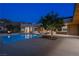 Stunning backyard pool and lounge area with a modern design, fire pit, and ample seating at 6 Rock Mount Ct, Henderson, NV 89012