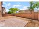 A backyard featuring gravel and a brick patio, offering a blank slate for outdoor relaxation and entertainment at 6125 Paddleboat St, North Las Vegas, NV 89031