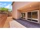 A backyard patio with pavers, offering a view of sliding glass doors and the exterior of the home at 6125 Paddleboat St, North Las Vegas, NV 89031