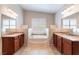 Well-appointed bathroom featuring dual sinks and a soaking tub at 6125 Paddleboat St, North Las Vegas, NV 89031