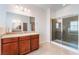 Bright bathroom features double sinks, tile floor, and glass-enclosed shower at 6125 Paddleboat St, North Las Vegas, NV 89031