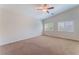 Bright bedroom with neutral carpet, ceiling fan, and plantation shutters on the windows at 6125 Paddleboat St, North Las Vegas, NV 89031