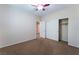 This carpeted bedroom features a ceiling fan, closet, and neutral colors, creating a cozy and inviting space at 6125 Paddleboat St, North Las Vegas, NV 89031