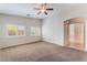Spacious bedroom with ample natural light, neutral carpet, and access to an ensuite bathroom at 6125 Paddleboat St, North Las Vegas, NV 89031