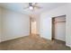 Bedroom features a ceiling fan, carpet, and closet at 6125 Paddleboat St, North Las Vegas, NV 89031