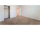 Bedroom featuring a carpeted floor, neutral walls, closet, and entry to another room provides comfort and convenience at 6125 Paddleboat St, North Las Vegas, NV 89031