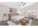 Staged primary bedroom featuring a stylish bed and seating area at 6125 Paddleboat St, North Las Vegas, NV 89031