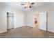 Bedroom with carpet, neutral walls, ceiling fan, closet and a doorway to an adjacent bathroom for added convenience at 6125 Paddleboat St, North Las Vegas, NV 89031