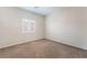 This bedroom features carpeted flooring, neutral walls, a ceiling fan, and a shuttered window for natural light at 6125 Paddleboat St, North Las Vegas, NV 89031