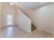Bright entryway with tile flooring, stairs leading to the second floor, and a door with glass panes at 6125 Paddleboat St, North Las Vegas, NV 89031