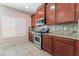 Well-lit kitchen featuring stainless steel appliances, granite countertops, and wood cabinetry at 6125 Paddleboat St, North Las Vegas, NV 89031