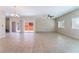 Open-concept living room with tile flooring, plantation shutters, and sliding doors to the backyard at 6125 Paddleboat St, North Las Vegas, NV 89031