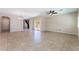 Spacious living room featuring tile floors, a ceiling fan, sliding glass doors, and lots of natural light at 6125 Paddleboat St, North Las Vegas, NV 89031
