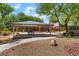Community playground featuring a shaded picnic area and play equipment surrounded by trees and landscaping at 6125 Paddleboat St, North Las Vegas, NV 89031