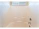 Bright and clean shower featuring white tiled walls, modern fixtures, and built-in shelving for added convenience at 6125 Paddleboat St, North Las Vegas, NV 89031