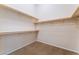 Walk-in closet offers ample storage with shelves and carpeted floors at 6125 Paddleboat St, North Las Vegas, NV 89031