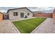 Landscaped backyard featuring a grass lawn area and low-maintenance gravel at 617 Sylvan St, Henderson, NV 89002