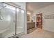 Modern bathroom featuring a glass-enclosed shower, double vanity, and tile flooring at 617 Sylvan St, Henderson, NV 89002
